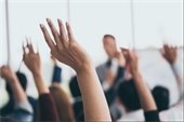 image of a arms raised in a classroom